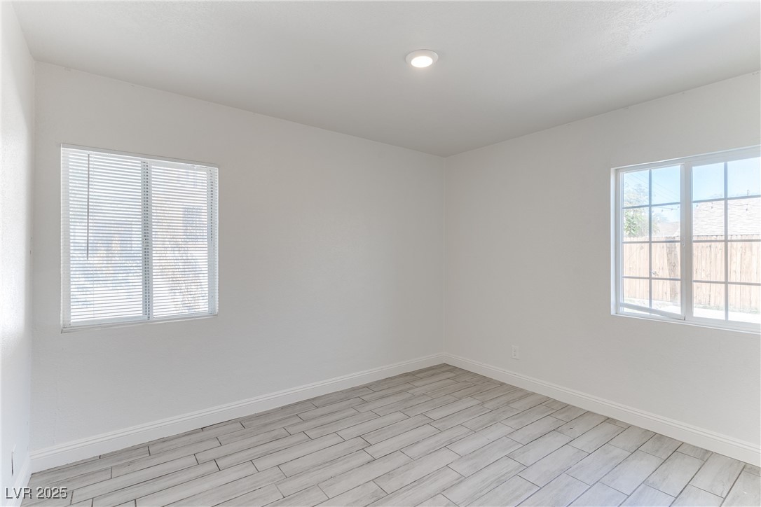 309 North 16th Street, Unit A Las Vegas, NV 89101 - Photo 13 of 23 Spare room with baseboards and wood tiled floors