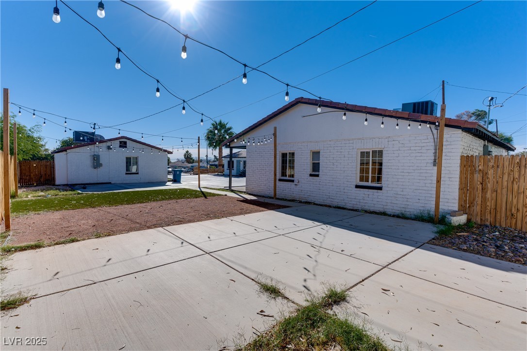 309 North 16th Street, Unit A Las Vegas, NV 89101 - Photo 21 of 23 Rear view of property with a patio and brick siding