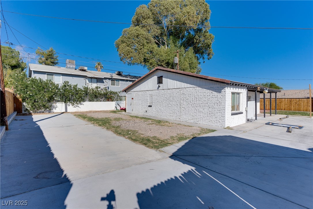 309 North 16th Street, Unit A Las Vegas, NV 89101 - Photo 5 of 23 View of side of home featuring a fenced backyard and brick siding