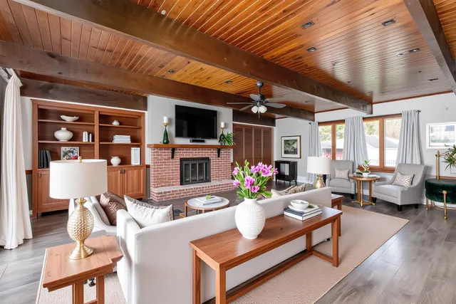 a living room with fireplace furniture and a flat screen tv
