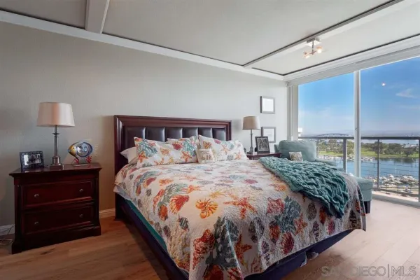 a large bed sitting in a bedroom next to a lamp