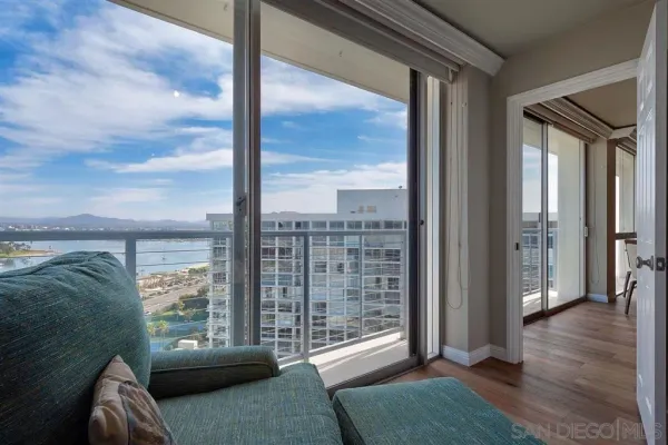 a view of a living room and a floor to ceiling window