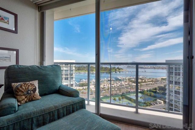 a living room with a large window and a couch