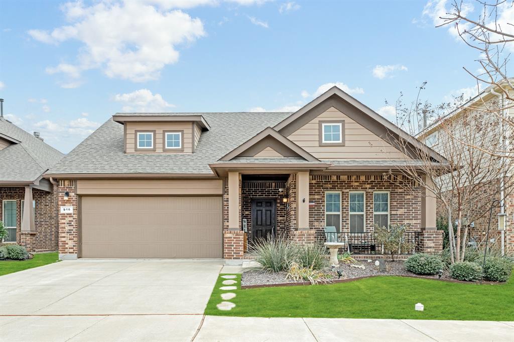 Craftsman house with a garage, a porch, and a front lawn