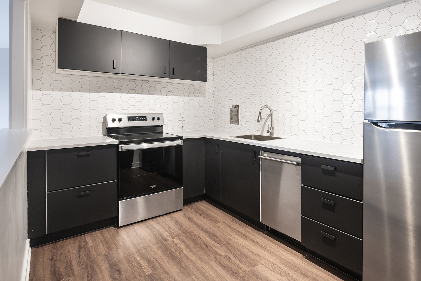 6118 North Sheridan Road, Unit 1003 Chicago, IL 60660 - Photo 7 of 11 a kitchen with a sink and a refrigerator