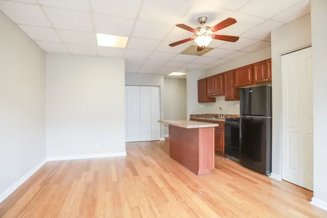 a kitchen with stainless steel appliances granite countertop a refrigerator and a stove top oven