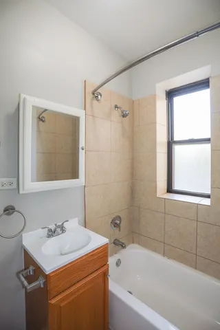 a bathroom with a sink toilet vanity and bathtub