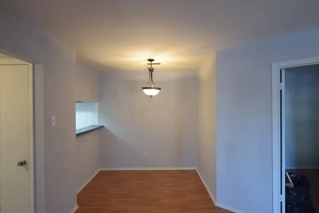 a view of a room with wooden floor and cabinet