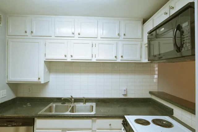 a kitchen with a sink and cabinets