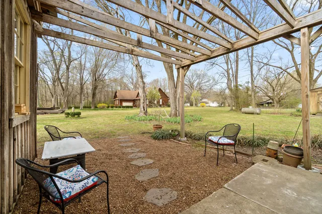 a backyard of a house with outdoor seating