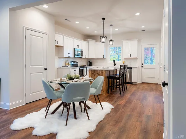 a view of a dining room with furniture and wooden floor