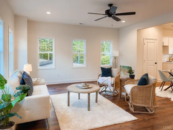 a living room with furniture and wooden floor