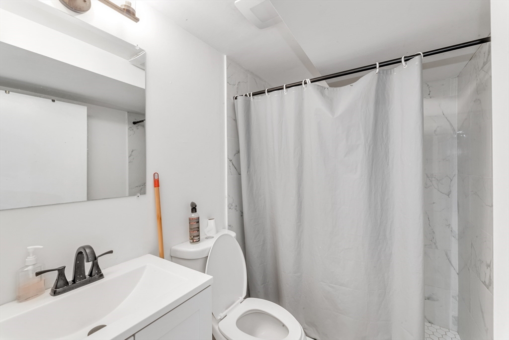 36 Brookledge Street Boston, MA 02121 - Photo 31 of 31 a bathroom with a sink and a mirror