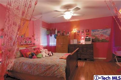 Undisclosed Address Glendale, CA 91202 - Photo 11 of 18 a bedroom with a bed and chandelier