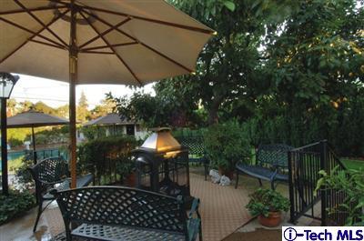 Undisclosed Address Glendale, CA 91202 - Photo 15 of 18 a backyard of a house with table and chairs under an umbrella