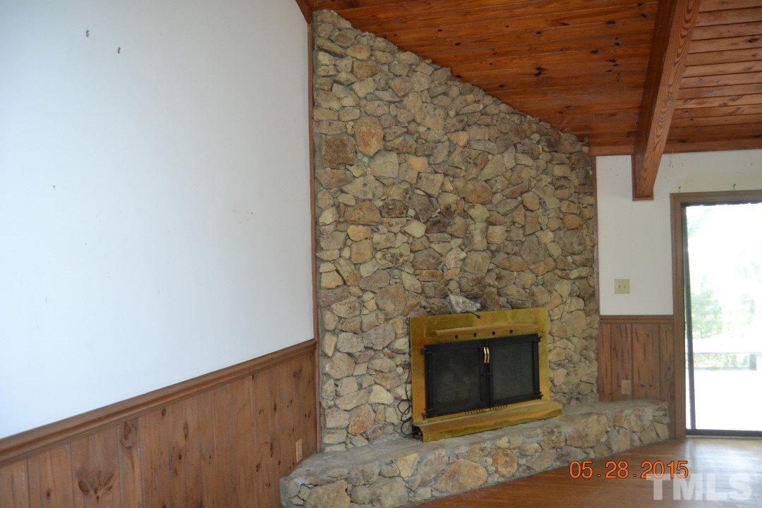 9611 Rougemont Road Bahama, NC 27503 - Photo 14 of 25 a view of a fireplace in an empty room