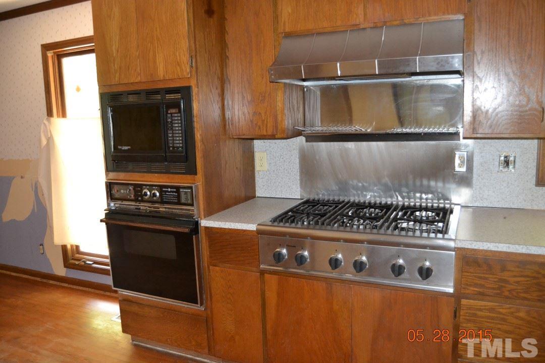 9611 Rougemont Road Bahama, NC 27503 - Photo 18 of 25 a kitchen with a stove and a microwave