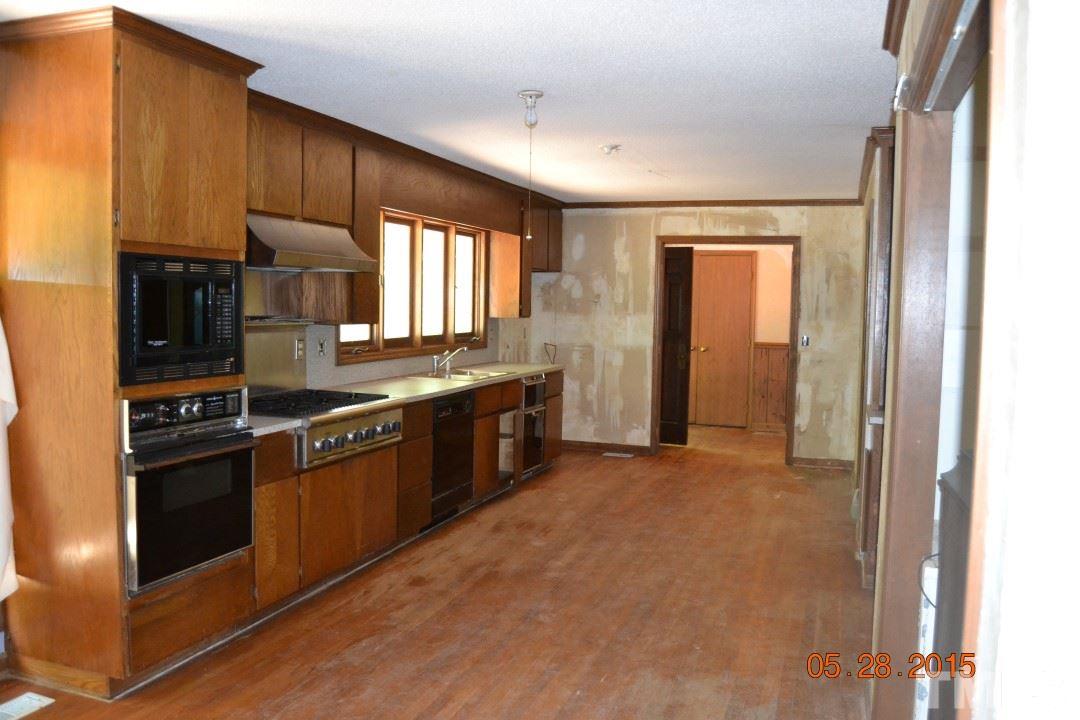 9611 Rougemont Road Bahama, NC 27503 - Photo 19 of 25 a kitchen with stainless steel appliances granite countertop a stove a sink and a refrigerator
