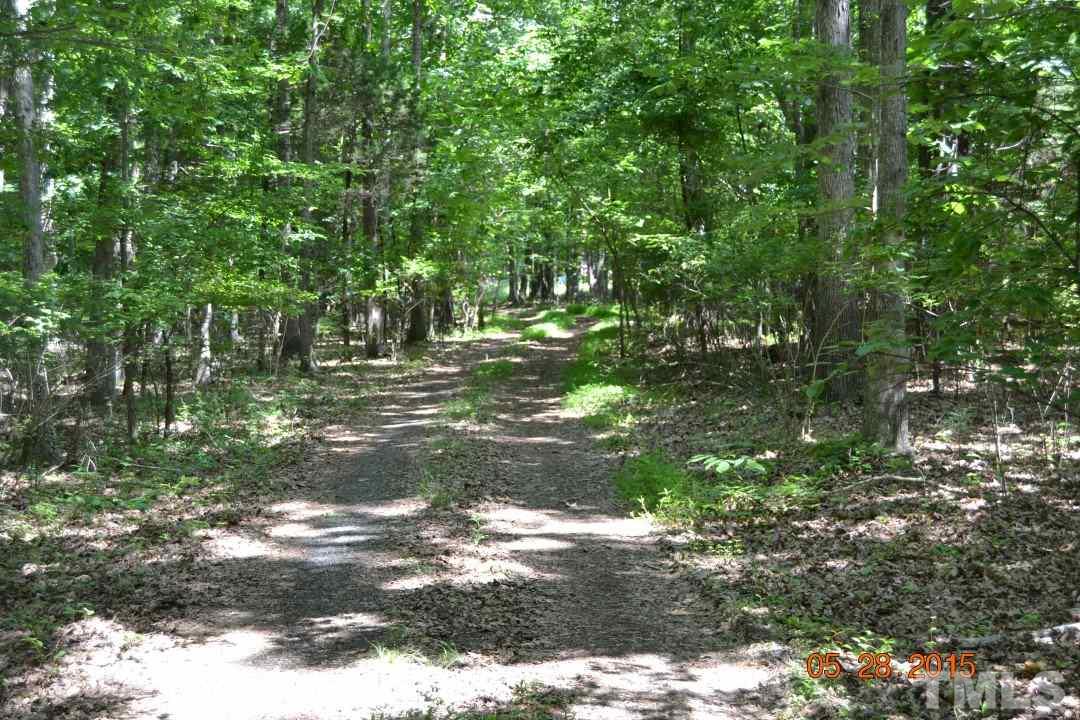 9611 Rougemont Road Bahama, NC 27503 - Photo 25 of 25 a backyard of a house with a yard and outdoor seating