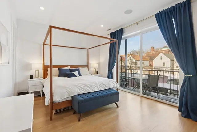 a bed sitting in a bedroom next to a balcony
