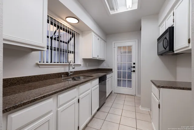 a kitchen with stainless steel appliances granite countertop a sink and a stove