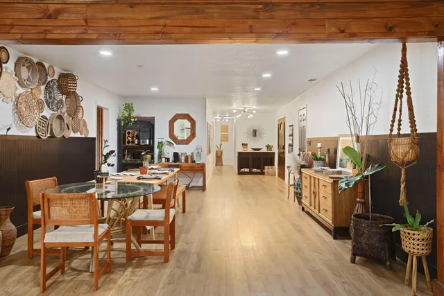 a kitchen with stainless steel appliances granite countertop a refrigerator a stove a sink dishwasher and white cabinets with wooden floor