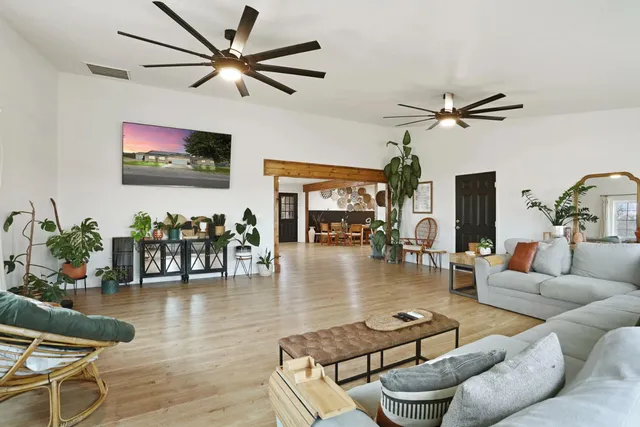 a bedroom with furniture and a flat screen tv