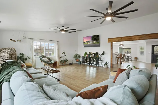 a bedroom with furniture and a wooden floor