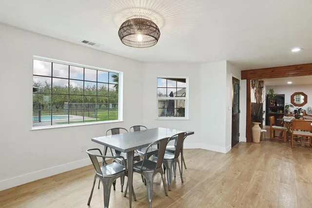 a walk in closet with a lot of stuff and hardwood floor