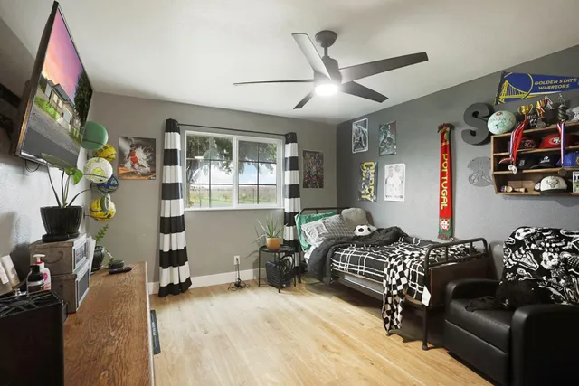 a bedroom with furniture and a flat screen tv