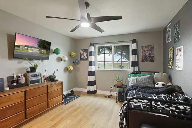 a bedroom with a bed and a flat screen tv