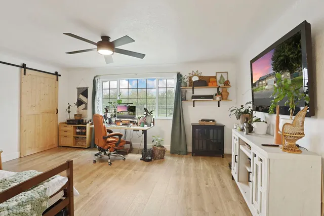 a living room with furniture and wooden floor