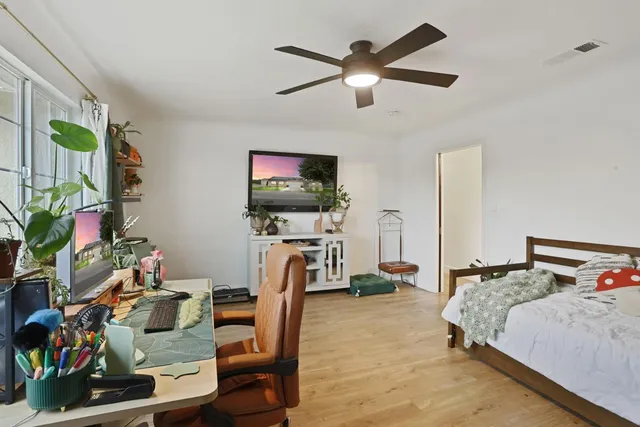 a bedroom with a bed and a dresser