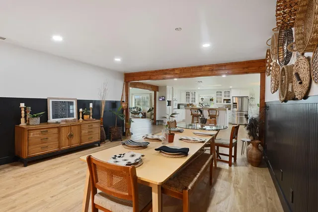 a living room with fireplace furniture and a large window