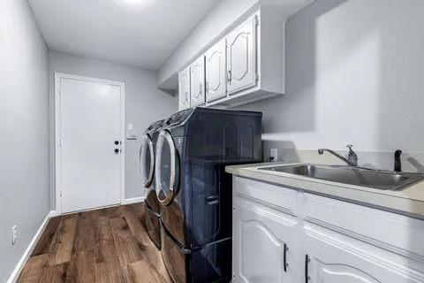 a view of a sink and washer dryer