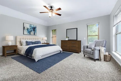 a spacious bedroom with a bed and a couch