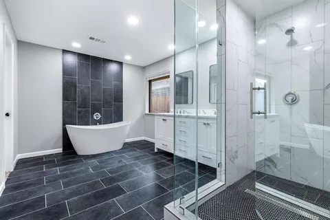 a large bathroom with a bathtub and shower