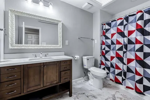 a bathroom with a sink toilet and shower