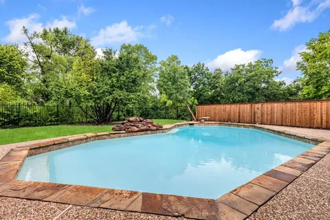 a view of swimming pool with seating space