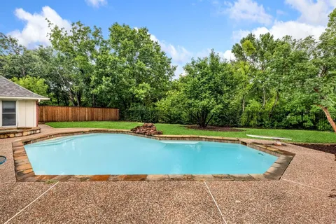 a front view of a house with a yard table and chairs