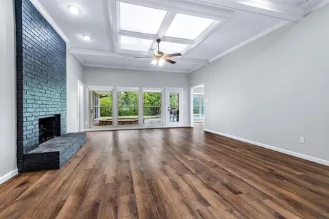 wooden floor in an empty room with a fireplace