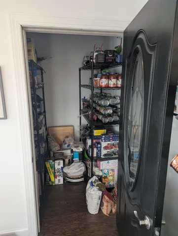 a view of a bedroom with furniture and window