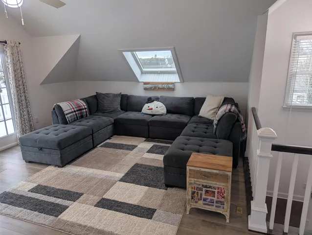 a bedroom with a bed tv and a window