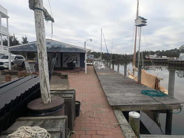 a spacious bedroom with a bed and wooden floor