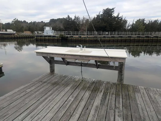 a spacious bedroom with a bed a table and a large mirror
