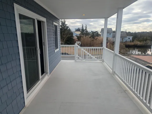 a dining room with furniture and a large window