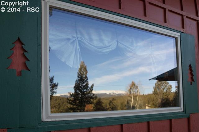 1038 Pinewood Road Florissant, CO 80816 - Photo 19 of 23 Reflection of Pikes Peak from picture window