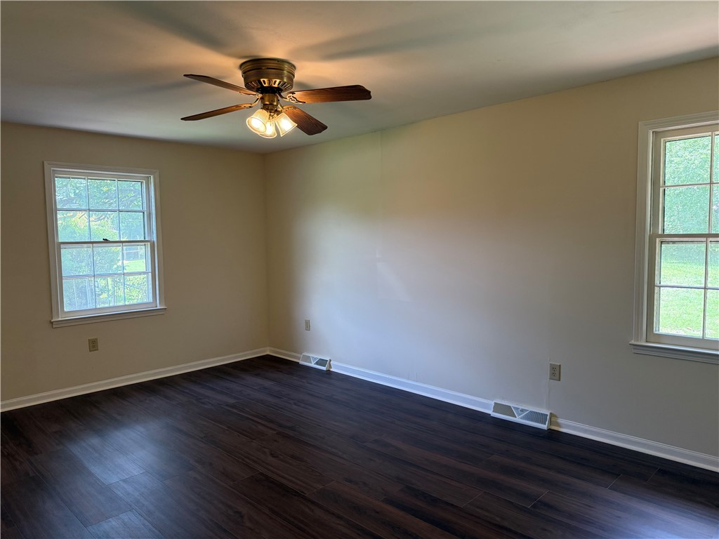 1507 East Calhoun Street Anderson, SC 29621 - Photo 13 of 18 A quiet bedroom, freshly updated, offers dark wood flooring and ample natural light.