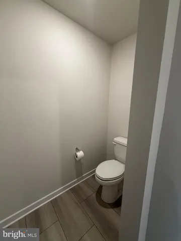 a white toilet sitting in a bathroom