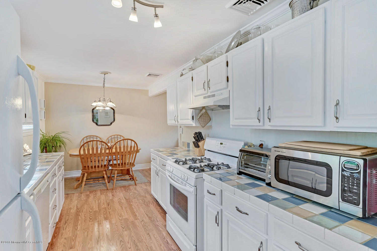 315 Stinson Road Brick, NJ 08723 - Photo 13 of 20 a kitchen with stainless steel appliances granite countertop a white cabinets a stove a sink and a wooden floors